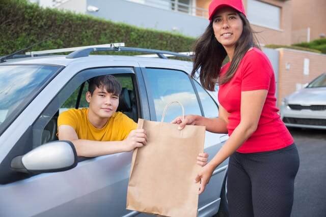 Driver handing off an order